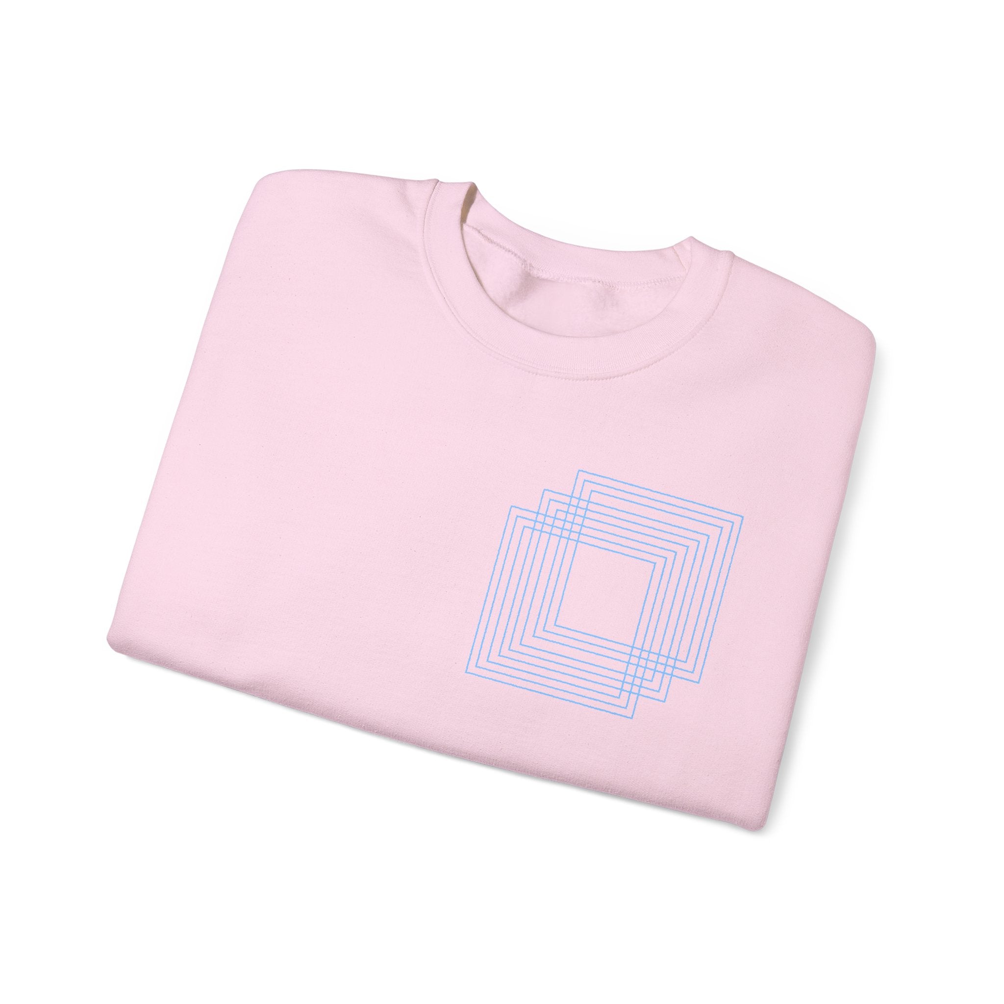 Light pink cotton sweatshirt with blue geometric square design, folded, Comfy Elegance