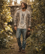 Man wearing beige patterned knit cardigan, graphic tee, and blue jeans outdoors, Comfy Elegance