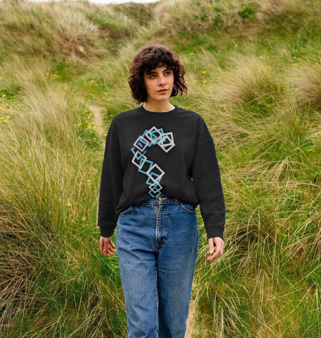 Woman wearing a black geometric print sweatshirt with blue and white shapes, Comfy Elegance